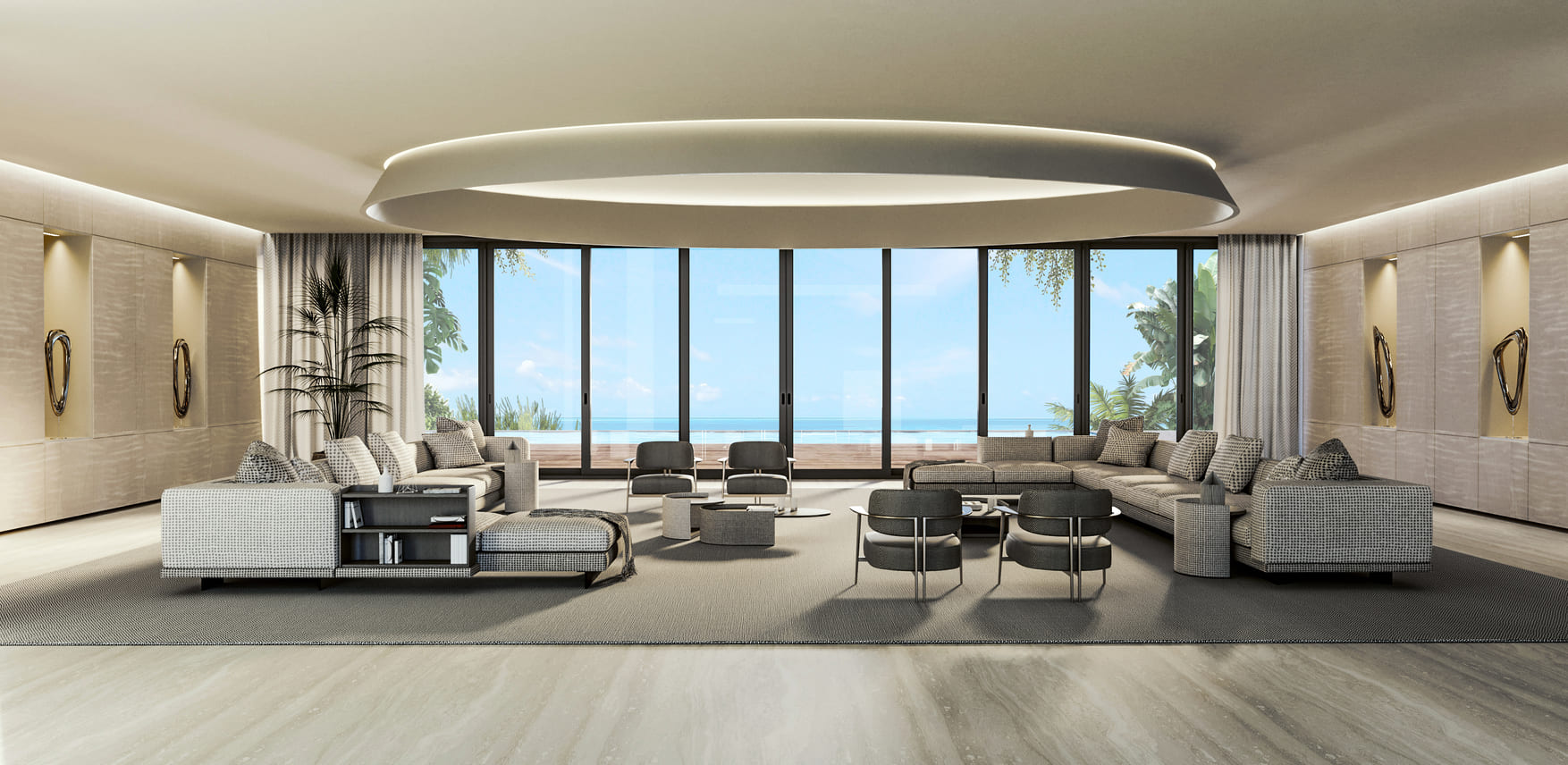 A bright and airy living room with plush seating, a large oval ceiling light, and floor-to-ceiling windows overlooking the ocean.