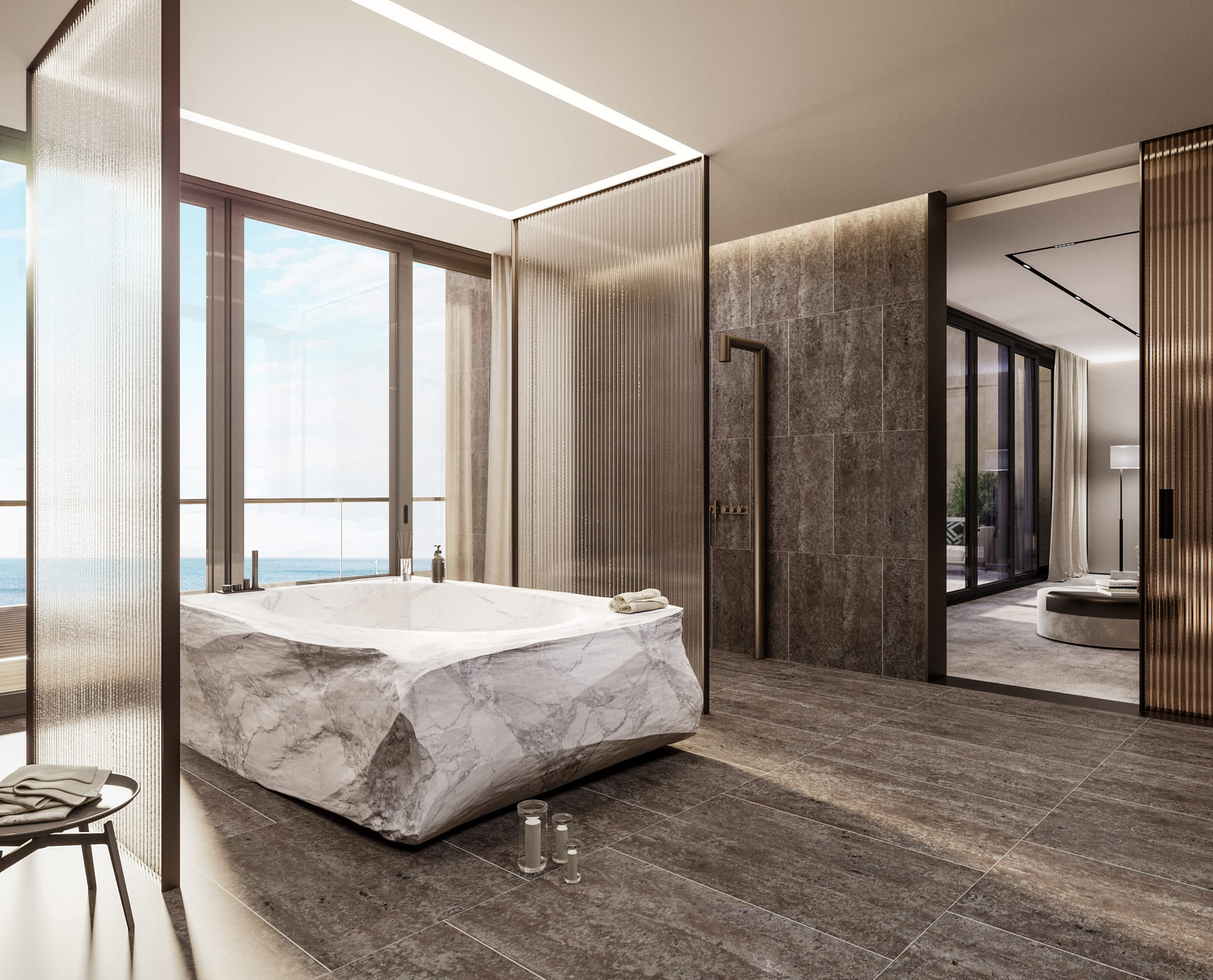 A minimalist bathroom with a large, marble-clad tub, dark stone flooring, and a panoramic ocean view through the window.